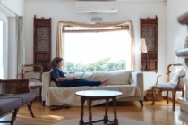 Women sitting on couch with open window