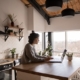 Woman sitting at kitchen island working on her laptop